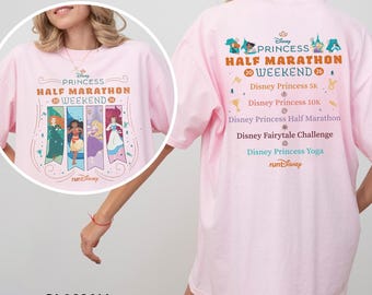 May include: A light pink t-shirt with the text "Princess Half Marathon Weekend" and Disney princess graphics. The back of the shirt features event details, including "Disney Princess 5K" and "Disney Princess 10K."