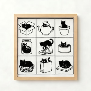 May include: A framed cross-stitch embroidery featuring a grid of nine squares, each displaying a black cat in a different setting, including a cardboard box, a teapot, a flower pot, a glass jar, a sneaker, a tin can, a basket, a paper bag, and a cushion.