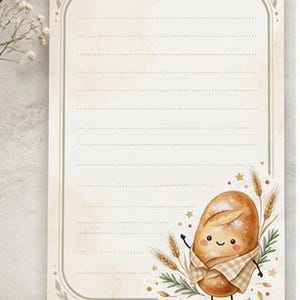 May include: A rectangular notepad with horizontal lines and a rounded border in muted green. The bottom right corner features a cartoon illustration of a smiling loaf of bread wearing a checkered cloth, surrounded by wheat stalks and small stars.