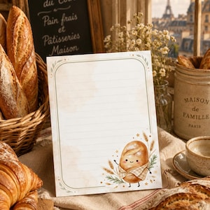 May include: A rectangular stationery sheet with horizontal lines and a sage green border. The bottom right corner features a cartoon illustration of a smiling bread loaf wearing a checkered apron, surrounded by wheat stalks and small stars.