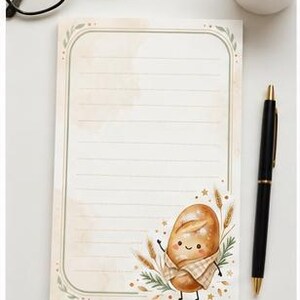 May include: A rectangular notepad with horizontal lines and a decorative border. The bottom right corner features a cartoon illustration of a smiling loaf of bread wrapped in a checkered cloth, surrounded by wheat stalks and small golden stars.