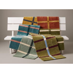 May include: A collection of rectangular rugs featuring a grid pattern with intersecting lines and small square accents. The rugs are displayed in various colors including mustard yellow, terracotta, teal, sage green, and olive with contrasting stripes.