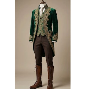 May include: A dark green velvet tailcoat featuring intricate gold embroidery along the lapels and cuffs, paired with a matching green patterned waistcoat, a white collared shirt with a light tie, brown trousers, and tall brown lace-up leather boots.