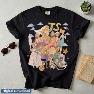 May include: A black short-sleeve t-shirt featuring a graphic print of multiple animated characters in various outfits, including a space suit, cowgirl attire, and gowns. The text TS is printed in large yellow letters above the characters.