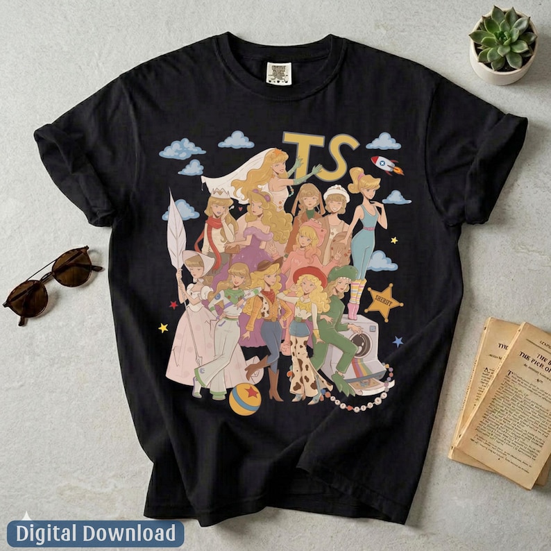 May include: A black short-sleeve t-shirt featuring a graphic print of multiple animated characters in various outfits, including a space suit, cowgirl attire, and gowns. The text TS is printed in large yellow letters above the characters.
