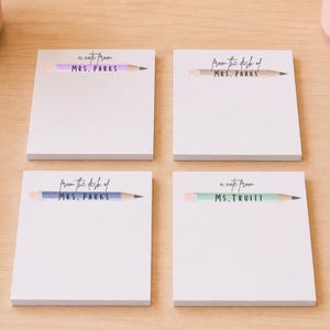 May include: Four square white paper notepads featuring a pencil graphic at the top. The top left pad says 'a note from MRS. PARKS', the top right says 'from the desk of MRS. PARKS', the bottom left says 'from the desk of MRS. PARKS', and the bottom right says 'a note from MS. TRUITT'.