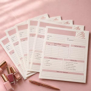 May include: A stack of white nail technician client record forms with pink accents, featuring sections for client information, service history, nail care notes, preferences, and aftercare tips, accompanied by three nail polish bottles and a gold pen.