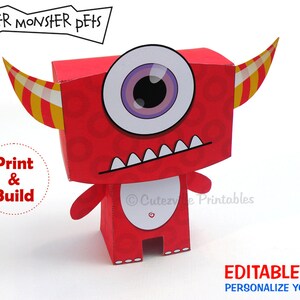 May include: Red papercraft monster with one large eye, a toothy grin, and yellow and white horns. The monster is standing on a white background. The text "Paper Monster Pets" is at the top of the image, and the text "Print & Build" is in a circle on the left side of the image. The text "Cutesy Printables" is at the bottom of the image. The text "Editable Text Personalize Yourself!" is at the bottom of the image.