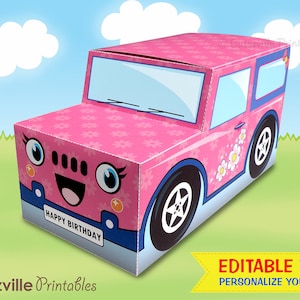 May include: A pink and blue cardboard car box with a happy face and the words "Happy Birthday" on the front. The car has a floral pattern and white wheels.