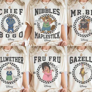 May include: Cream-colored t-shirts featuring cartoon characters from the movie Zootopia. Each shirt displays a character's name and image within a checkered circle. The characters include Chief Bogo, Nibbles Maplestick, Mr. Big, Bellwether, Fru Fru, and Gazelle.