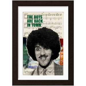 May include: A black and white photo of a man with an afro hairstyle. The man is smiling and wearing a suit. The background is a collage of music sheet paper with the text "THE BOYS ARE BACK IN TOWN" in green.