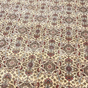 May include: A rectangular area rug featuring a dense, repeating floral and geometric pattern in shades of cream, deep red, dark brown, and black. The intricate design consists of interconnected medallions and scrolling vine motifs across the surface.