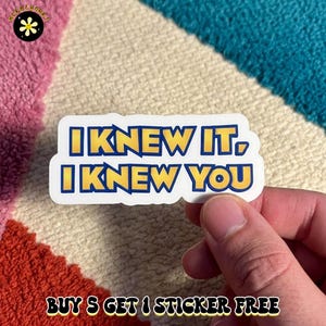 May include: A die-cut vinyl sticker featuring the text I KNEW IT, I KNEW YOU in bold yellow letters with a dark blue outline against a white background. The sticker has a smooth, matte finish and is shaped to follow the contour of the text.