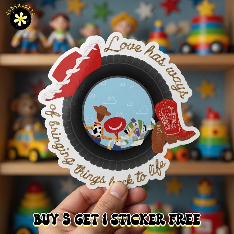 May include: A circular sticker featuring a black tire frame with a red cowboy hat on the top left and a red cowboy boot on the right. Inside the tire, three cartoon characters stand against a blue sky. The text reads, Love has ways of bringing things back to life.