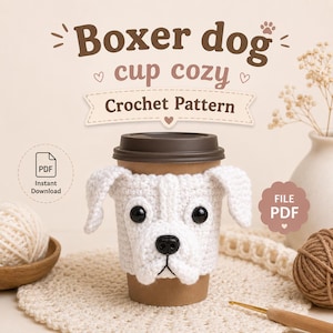 May include: A white crochet cup cozy shaped like a boxer dog face with black plastic eyes and a black nose, wrapped around a brown paper coffee cup. The image includes text that reads Boxer dog cup cozy Crochet Pattern and PDF Instant Download.