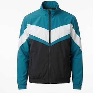 May include: A zip-up jacket featuring a colour-blocked design with a teal upper section, a white chevron stripe across the chest, and a black lower section. The jacket includes a stand-up collar, long sleeves with ribbed cuffs, and a black front zipper.