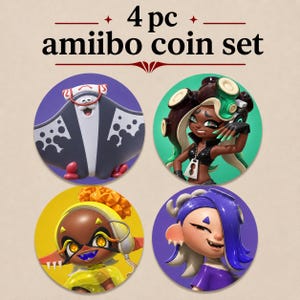 May include: A 4-piece amiibo coin set featuring circular designs with characters from the Splatoon series. The text 4 pc amiibo coin set is printed at the top. Each coin displays a distinct character illustration against a solid color background.