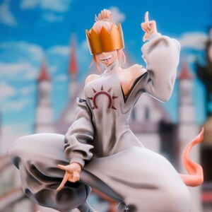 May include: A figurine of a character in a white robe and a gold crown, with orange accents. The figure is posed on a gray rock base, with a cityscape in the background. The character is making hand gestures.