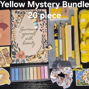May include: A 20-piece Yellow Mystery Bundle containing a notebook with a fox illustration, a journal with the text "Surround yourself with beauty," a mesh pencil case, yellow pens, a yellow headband, sticky notes, stickers, and a scrunchie.