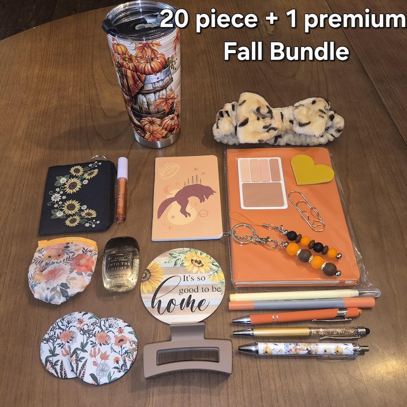 May include: A 20 piece + 1 premium Fall Bundle including a pumpkin-themed tumbler, a leopard print headband, a sunflower wallet, a fox notebook, an orange planner, pens, a floral pouch, hand sanitiser, a round sign, and hair accessories.