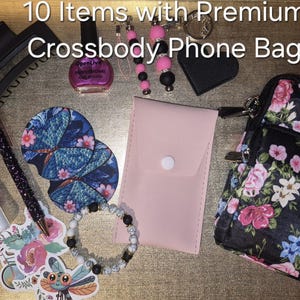 May include: A collection of 10 items including a floral crossbody phone bag, a pink pouch, a black hair clip, a bottle of pink nail polish, a glittery pen, two round coasters, a beaded bracelet, a keychain, and a sticker of a dragonfly.