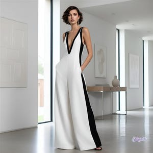 May include: A sleeveless jumpsuit featuring a deep V-neckline, wide-leg trousers, and a colour-blocked design with a white front and back panel contrasted by solid black side panels that extend from the armholes down to the hem of the garment.