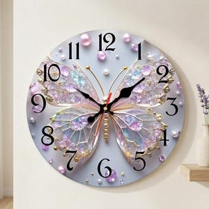 May include: A round wall clock featuring a large, iridescent butterfly with translucent wings in shades of purple and blue. The clock face has black Arabic numerals, black hour and minute hands, a red second hand, and decorative pearl accents.