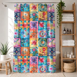 May include: A shower curtain featuring a vibrant patchwork design of colorful floral and abstract patterns in shades of pink, orange, yellow, and blue. The curtain hangs from a silver rod and displays a repeating grid of square motifs.