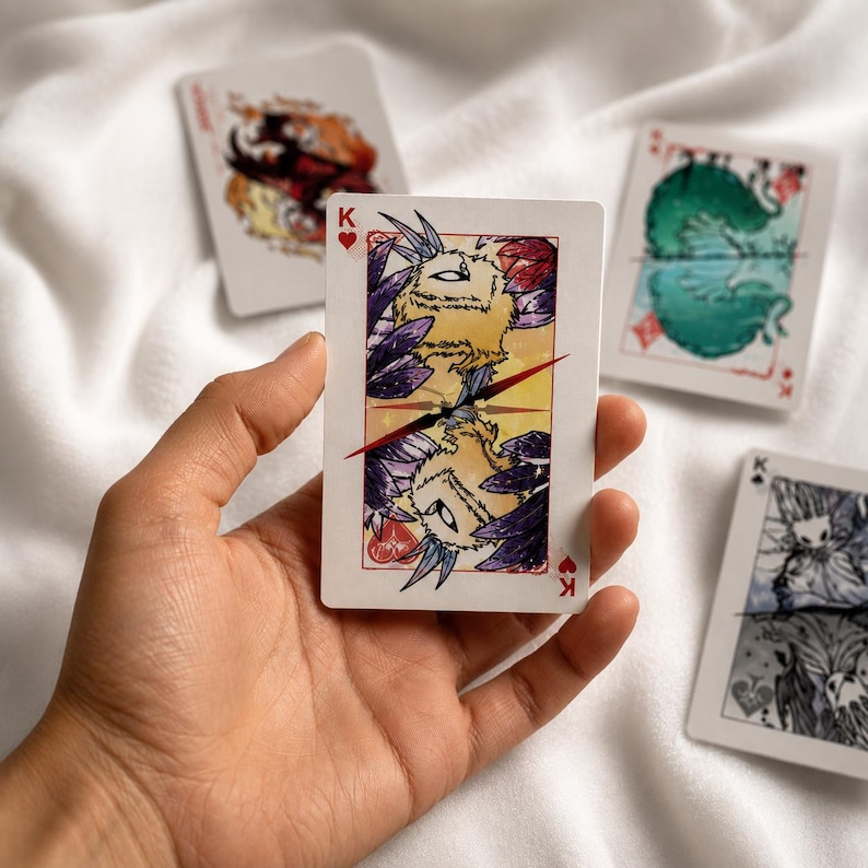 Fantasy king playing card held in hand featuring cute creature illustration and collectible card game inspired artwork