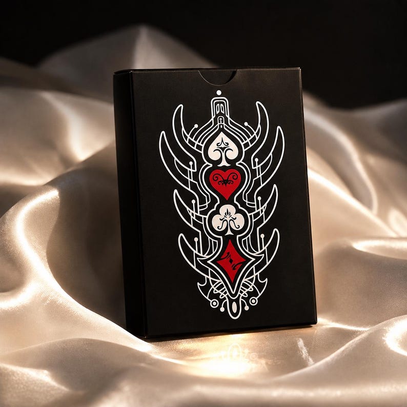 Luxury black playing card tuck box with gothic suit symbols and elegant fantasy card deck packaging design