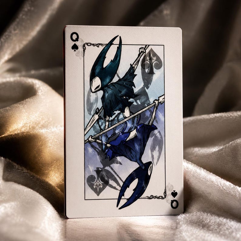 Fantasy playing card featuring dark insect inspired character artwork with elegant queen of spades design on textured card stock