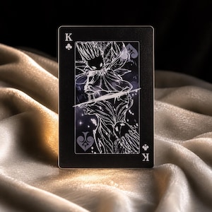 King of clubs fantasy playing card with dark monochrome artwork and mystical creature illustration on black background