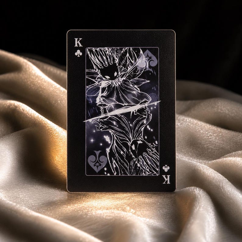 King of clubs fantasy playing card with dark monochrome artwork and mystical creature illustration on black background