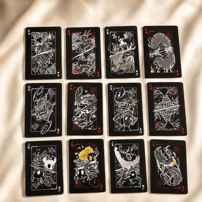 Fantasy playing card deck with black gothic design featuring illustrated creature face cards and luxury collector aesthetic