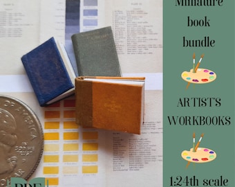 May include: A set of three miniature artist's workbooks in 1:24th scale. The books are bound in blue, green, and brown covers. The books are sitting on a table with a color chart and a US quarter.
