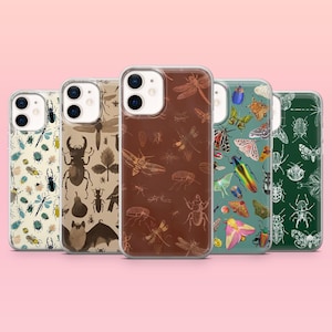 May include: A collection of five phone cases with insect illustrations. The cases feature various designs, including beetles, butterflies, and dragonflies, in colors like brown, green, and cream. The cases are displayed against a pink background.
