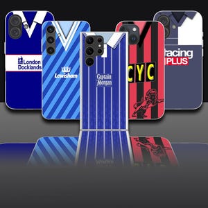 May include: A collection of five smartphone cases featuring various sports jersey designs. The cases display patterns including blue and white stripes, red and black vertical stripes with a lion graphic, and text such as London Docklands, Lewisham, Captain Morgan, CYC, and Racing Plus.