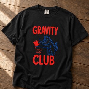 Gravity Club Cat T-Shirt Funny Cat Knocking Coffee Mug Off Table Tee Two Color Cat Lover Graphic Tee Gift imagem 6