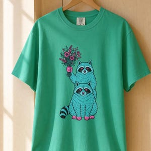 Two Raccoons Holding Wildflowers T-Shirt, Teal and Pink Riso Style Raccoon Tee, Cottagecore Animal Graphic Shirt, Soft Protest Gift image 14
