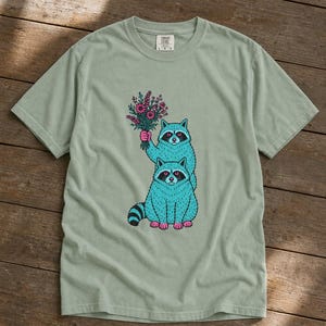 Two Raccoons Holding Wildflowers T-Shirt, Teal and Pink Riso Style Raccoon Tee, Cottagecore Animal Graphic Shirt, Soft Protest Gift image 5