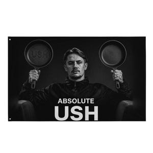 May include: A black and white graphic featuring a person holding two cast iron skillets, one with the text USH embossed on the base. The text ABSOLUTE USH is printed in large white letters at the bottom of the rectangular banner.