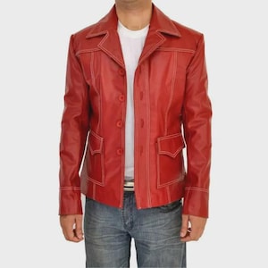 May include: A red leather jacket with white stitching details. The jacket has a button-up front, two front pockets, and a classic collar. The jacket is worn over a white t-shirt and blue jeans.