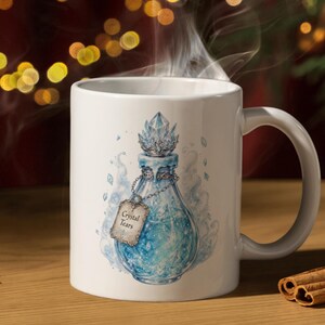May include: A white ceramic mug featuring a graphic illustration of a blue potion bottle with a crystal stopper and a hanging tag that reads Crystal Tears. The bottle is surrounded by swirling blue mist and small floating crystal shards.