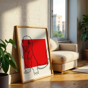 Puede incluir: Una lámina de arte enmarcada que presenta un dibujo de líneas negras de una criatura bípeda con una llama en la cola, centrada sobre un cuadrado rojo sólido en un fondo blanco. La obra está dentro de un marco de madera clara.