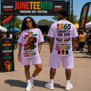 May include: A light purple t-shirt and shorts set featuring Juneteenth graphics. The front displays a person with a crown and the text 'Juneteenth Freedom is Timeless'. The back features '1865 Wasn't the End It Was the Beginning' with broken chains.