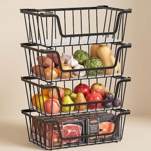 May include: A four-tier stackable black wire storage basket unit with an open front design. The baskets contain various produce including potatoes, onions, garlic, artichokes, squash, apples, pears, pomegranates, figs, and packaged salmon steaks.