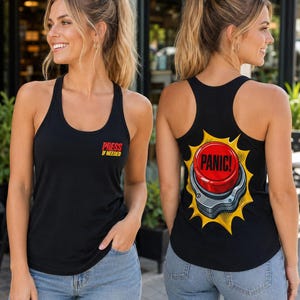 May include: A black racerback tank top featuring a graphic on the front left chest that reads "PRESS IF NEEDED" in red and yellow text. The back of the tank top displays a large, vibrant illustration of a red panic button with yellow accents.
