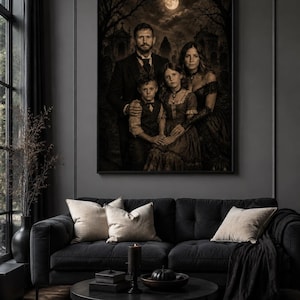May include: A framed wall art print depicting a family portrait in a dark, sepia-toned cemetery setting under a full moon. The image features a man, a woman, a young boy, and a young girl dressed in formal attire, displayed above a black sofa.