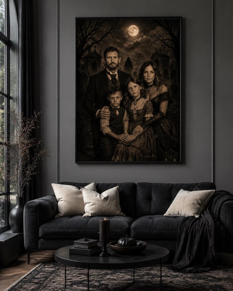May include: A framed wall art print depicting a family portrait in a dark, sepia-toned cemetery setting under a full moon. The image features a man, a woman, a young boy, and a young girl dressed in formal attire, displayed above a black sofa.
