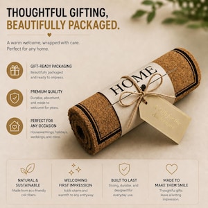 May include: A rolled brown coir doormat with a black border, wrapped in a white paper band featuring the text HOME and a heart icon. A tan gift tag tied with twine is attached to the band, which bears the text A Gift for the Andersons.